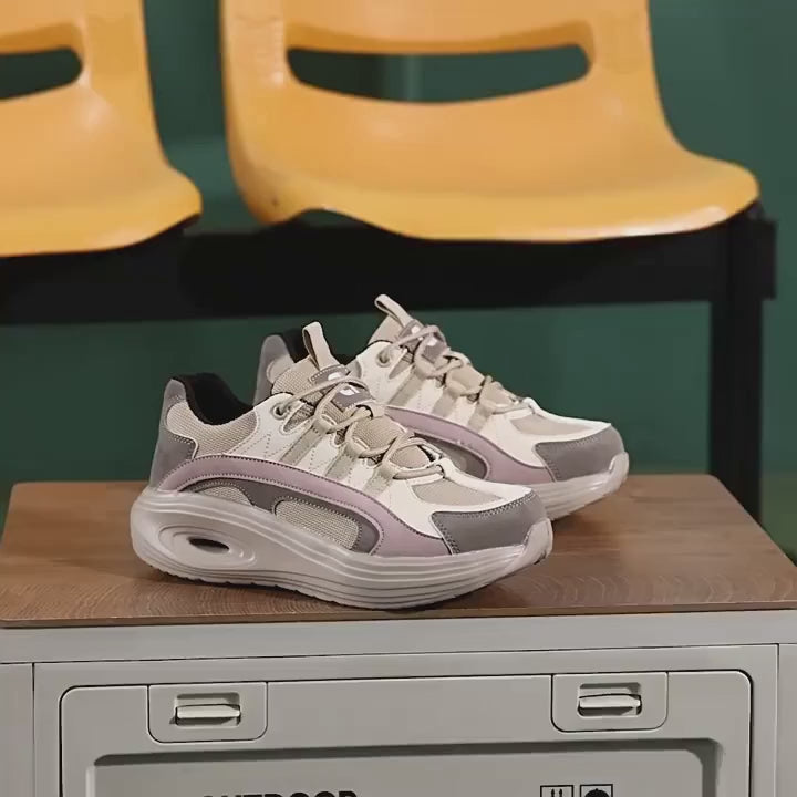 SafeStep women's fashion safety sneakers in grey, featuring a breathable mesh upper, lightweight cushioned sole, and protective steel toe. The video demonstrates the stylish athletic design and secure lace-up fit for comfortable all-day work wear