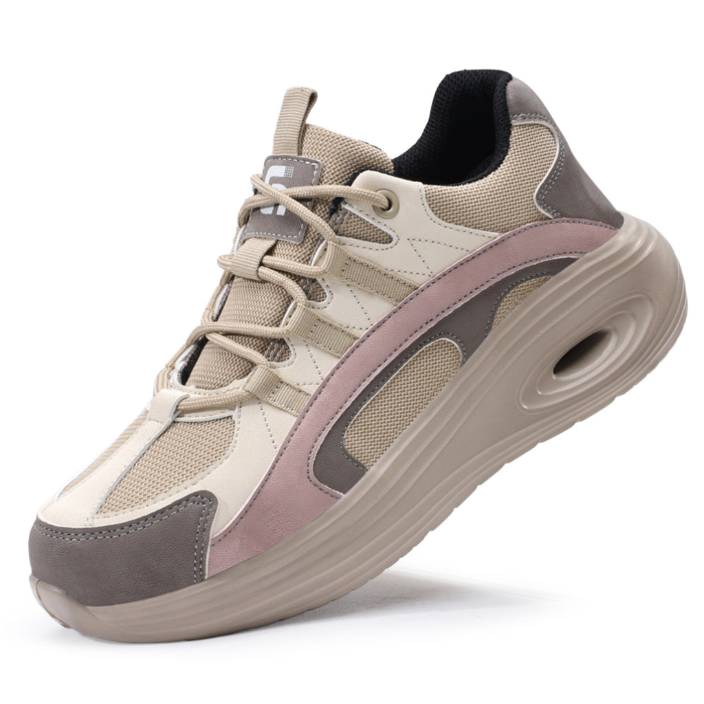 Main product view of SafeStep women's safety sneakers featuring a grey and pink athletic design with a thick shock-absorbing sole and breathable mesh upper.