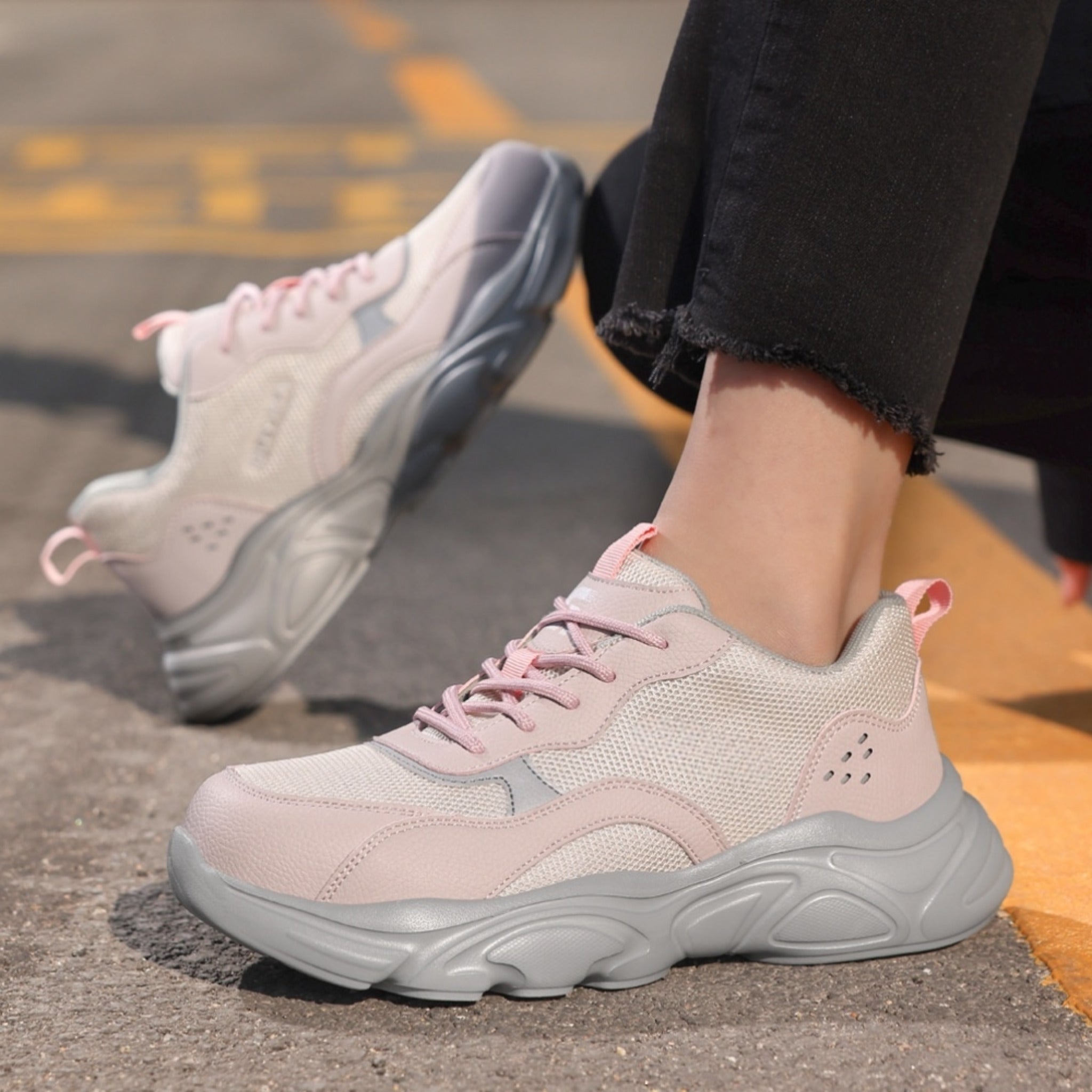 Outdoor lifestyle view of SafeStep women's pink steel toe safety sneakers, featuring a stylish mesh design and athletic fit for daily work wear.